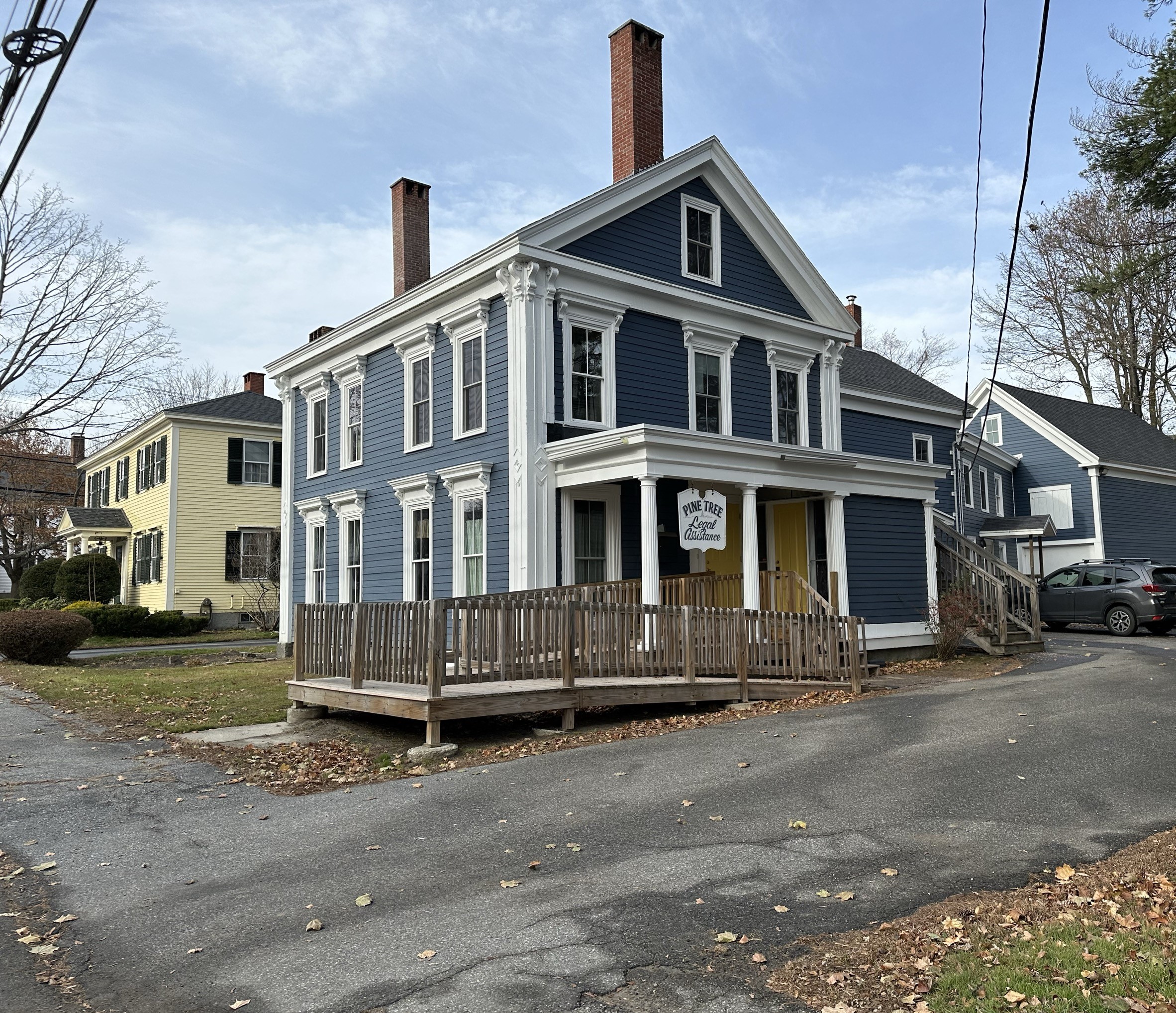 A photo of the PTLA Augusta office building - a big blue and white farmhouse with a wooden ramp out front